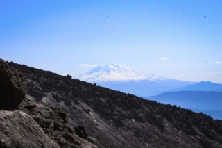 Mount Adams is seen beyond a ridge of Mount St. Helens (1) Mount Adams is seen beyond a ridge of Mount St. Helens. Photo by Eric Schwartz