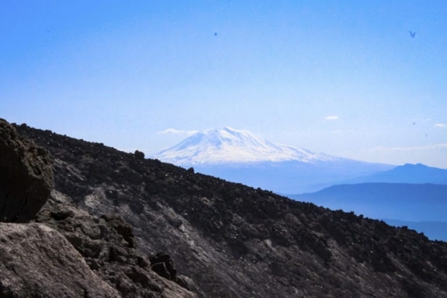 Mount Adams is seen beyond a ridge of Mount St. Helens. Photo by Eric Schwartz