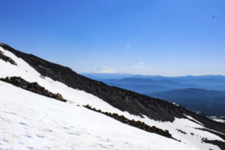 Mount Adams is seen beyond a ridge of Mount St. Helens Mount Adams is seen beyond a ridge of Mount St. Helens. Photo by Eric Schwartz