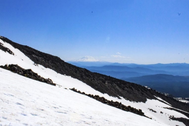 Mount Adams is seen beyond a ridge of Mount St. Helens. Photo by Eric Schwartz