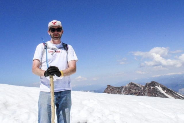 Reporter Eric Schwartz poses for a photo at the summit of Mount St. Helens. Photo by Eric Schwartz