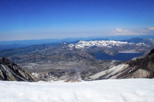 Steam rises from the crater of Mount St. Helens as Spirit Lake is seen in the background at the summit of Mount St. Helens. Photo by Eric Schwartz