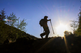 The sun shines as a climber walks across a small ridge at Mount St. Helens The sun shines as a climber walks across a small ridge at Mount St. Helens. Photo by Eric Schwartz