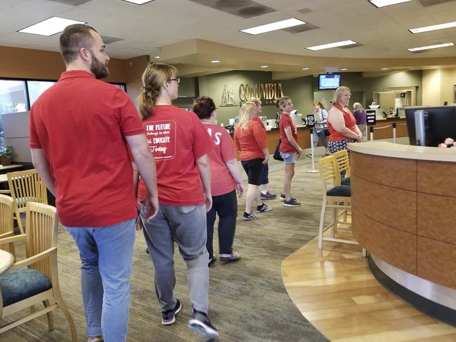 Evergreen school teachers marched into a Columbia Credit Union managed by school board Director Julie Bocanegra on Tuesday, to tell her Superintendent John Steach wasn’t bargaining in good faith. Photo courtesy Evergreen Education Association