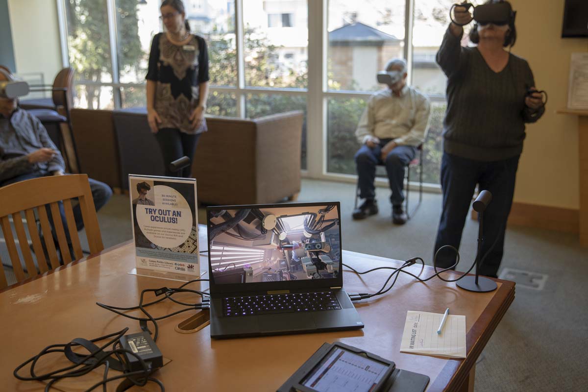 Staff at the Camas Public Library, help members of the public use virtual reality headsets to learn about a variety of topics, from Mt. Everest to the human body. Photo by Jacob Granneman