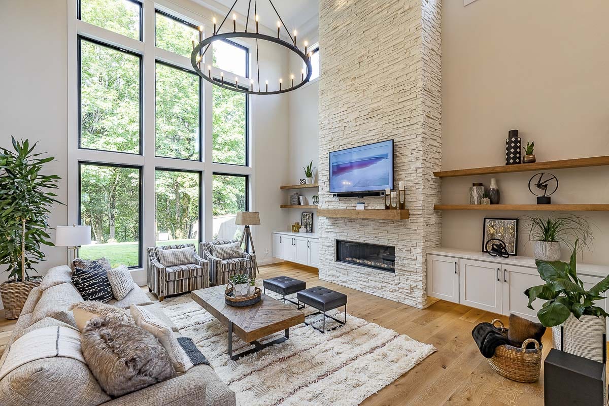 The great room of Glavin Homes Mira Verde features three tiers of windows and a masonry fireplace. Photo by Mike Schultz