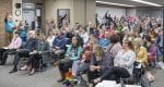 The crowd at Monday’s Battle Ground School District Board of Directors meeting holds up their hands in opposition to a new proposed comprehensive sexual education curriculum for high school students. Photo by Mike Schultz