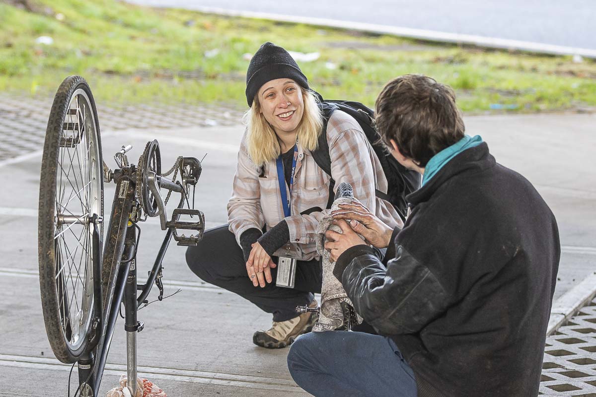 Ashley Gaffney, outreach case manager for Share, speaks with a homeless man during the annual Point in Time count on Thursday. Photo by Mike Schultz