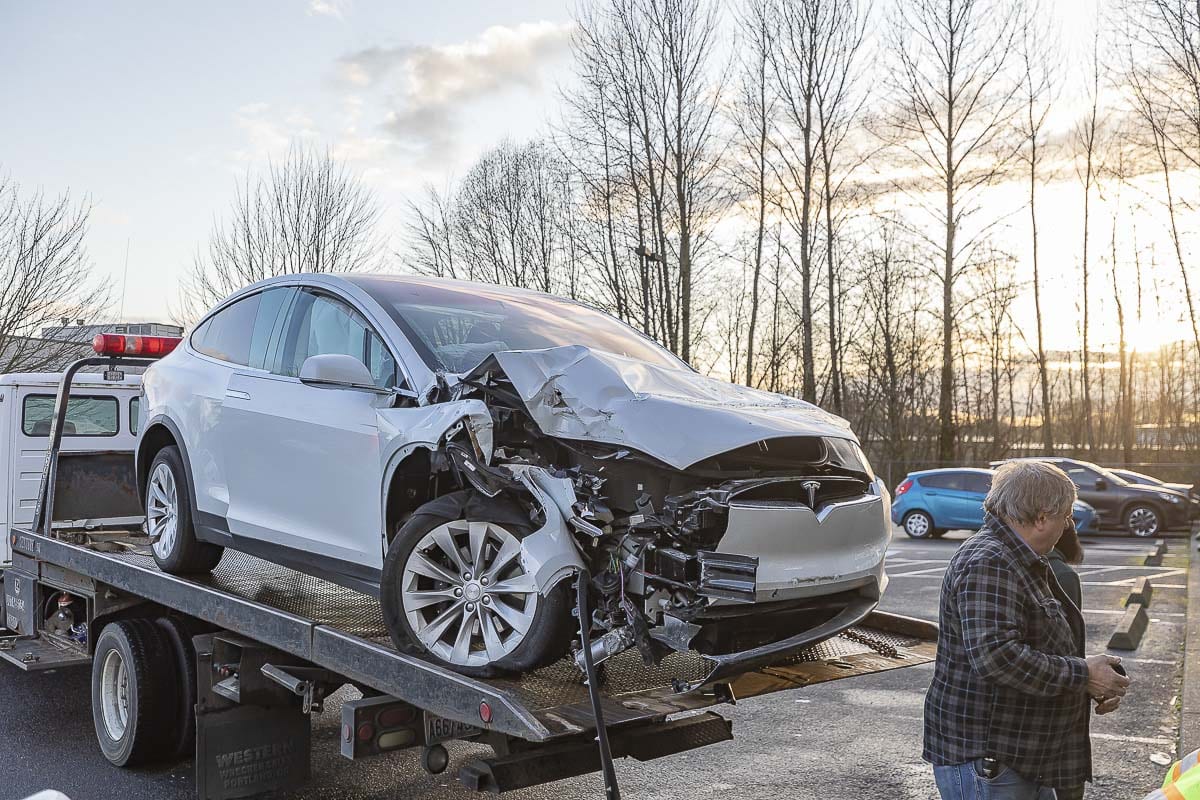 The driver of this Tesla says the vehicle malfunctioned, causing it to crash into the front of a Woodland Subway restaurant on Sunday. Photo by Mike Schultz