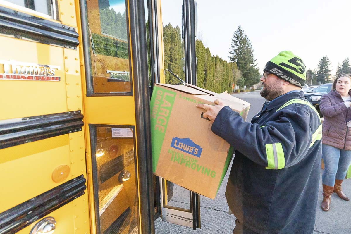 Mike Vestal, a bus mechanic for Evergreen Public Schools, was one of dozens who volunteered to help load food on the district’s buses on Tuesday as the district delivered food throughout the neighborhoods. Photo by Mike Schultz