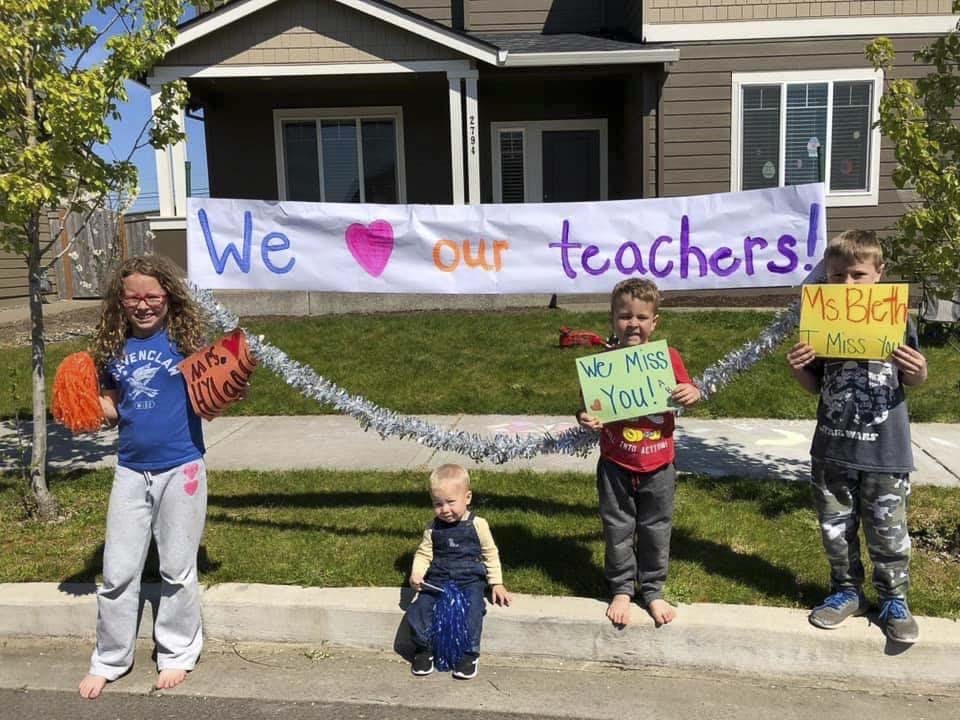 Ridgefield students line the streets in anticipation of seeing their teachers drive past during a special car parade organized by Union Ridge Elementary School. Photo courtesy of Ridgefield Public Schools