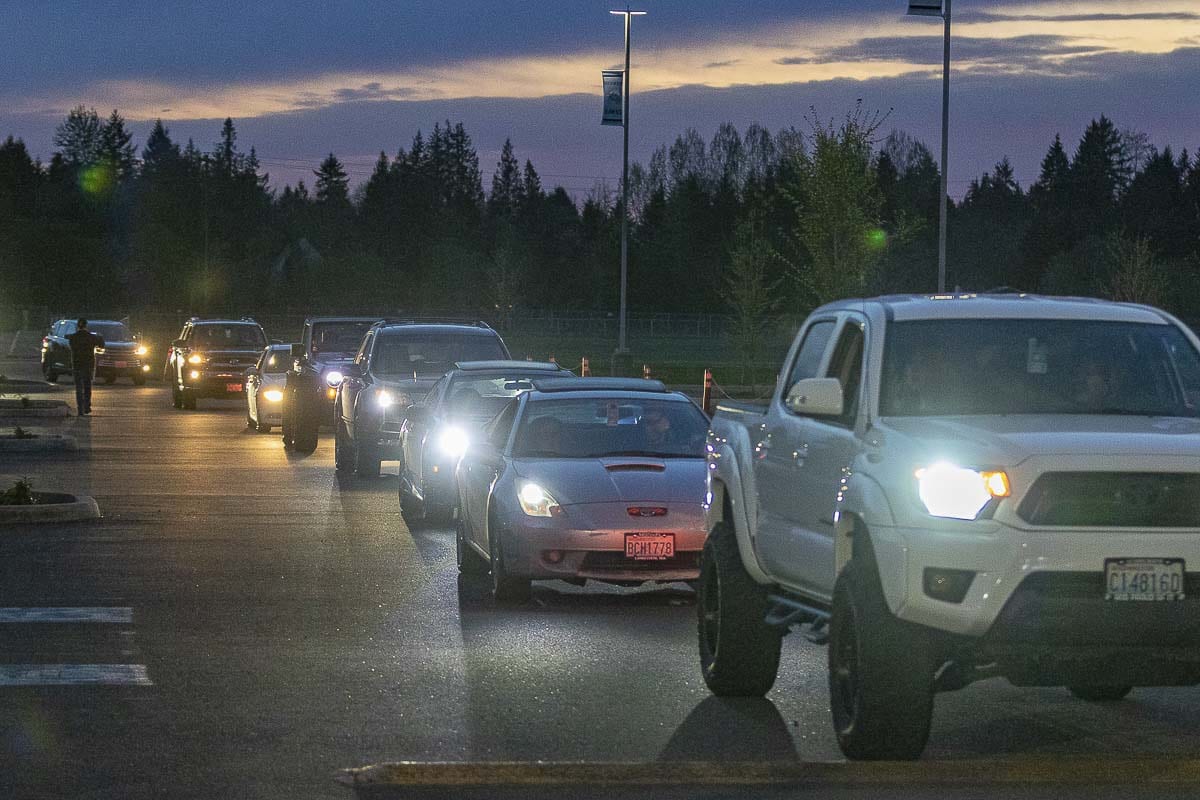 Dozens of cars slowly drove by the stadium at Hockinson High School. Drivers honked the horns to celebrate the Hawks. Photo by Mike Schultz
