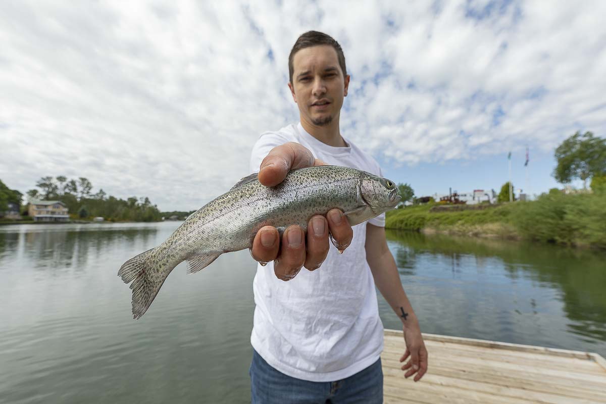 Lucas Holmgren shows off a trout he caught out of Horseshoe Lake Tuesday. Photo by Mike Schultz