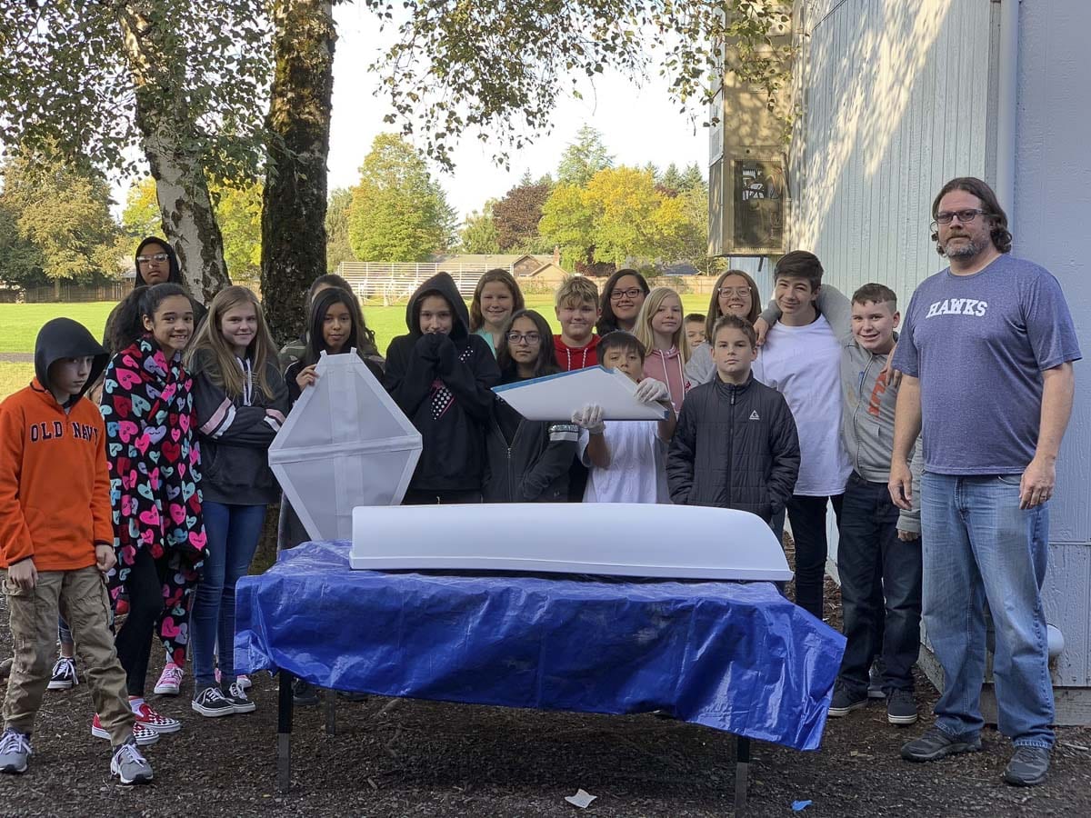 Wy’east Middle School science teacher Joe Boken (right) can be seen here with his seventh grade class and their mini-boat, back in 2019. Photo courtesy of CRMM