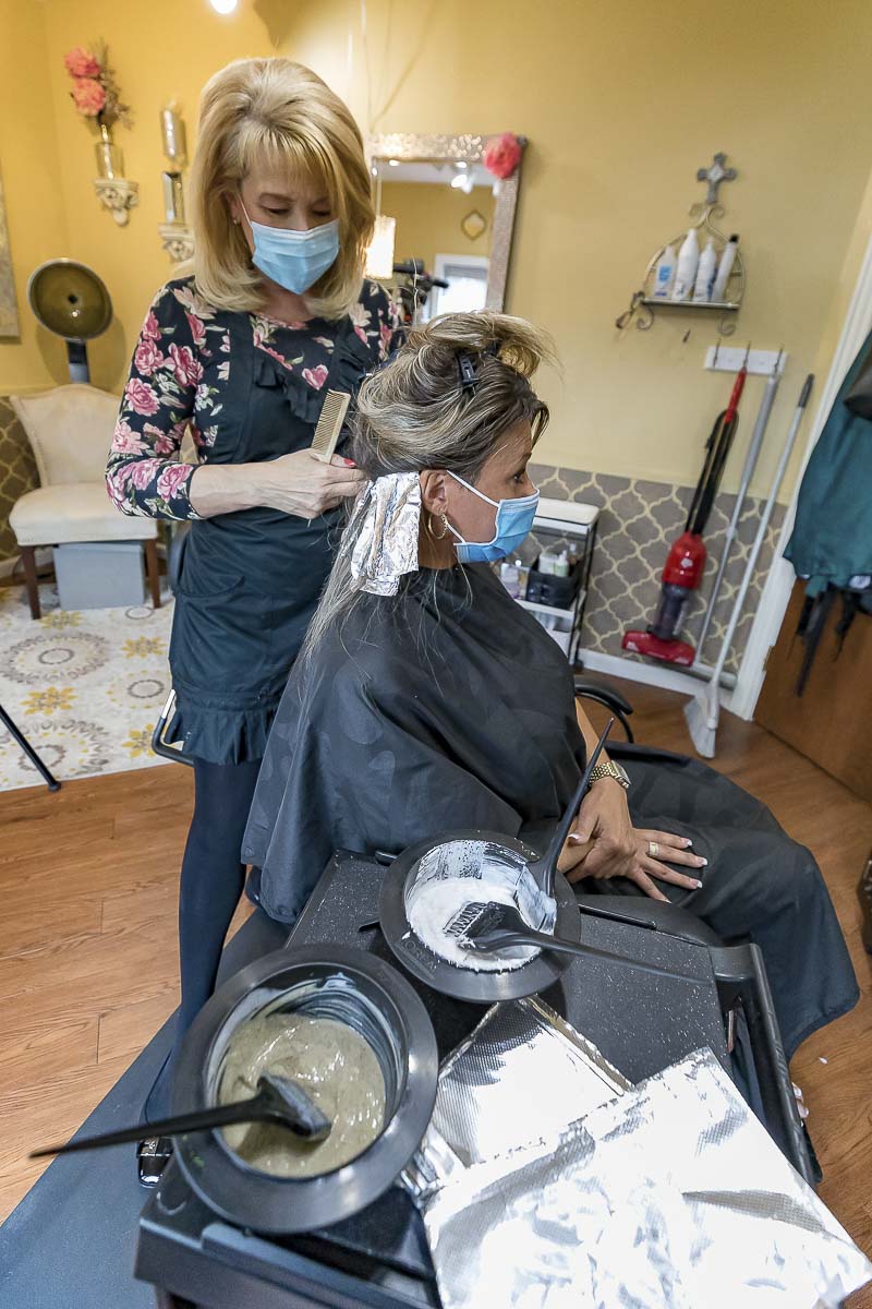 Vancouver hair stylist Betty Rae Wiant works with client Lisa Jansen Sunday at Seasons Span and Salon in Vancouver. Photo by Mike Schultz