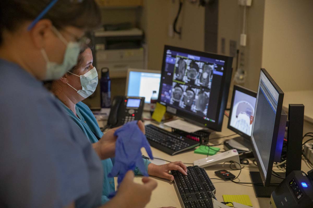 MRI technicians are shown here reviewing imaging from a patient. The images are then sent to the patient's physician for review and diagnostic use. Photo by Jacob Granneman