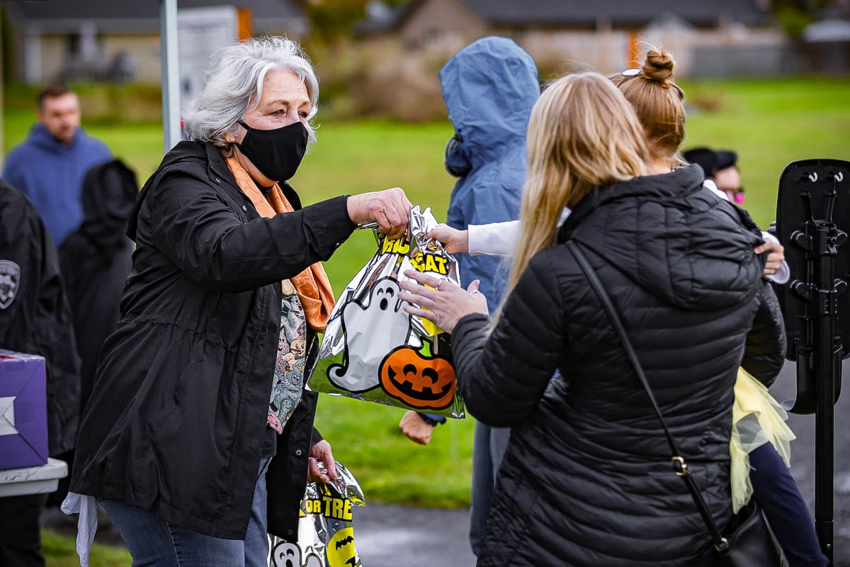 Washougal Mayor Molly Coston is seen here giving pre-packed candy bags to children in costume at this year’s Pumpkin Harvest Festival. Photo by Mike Schultz