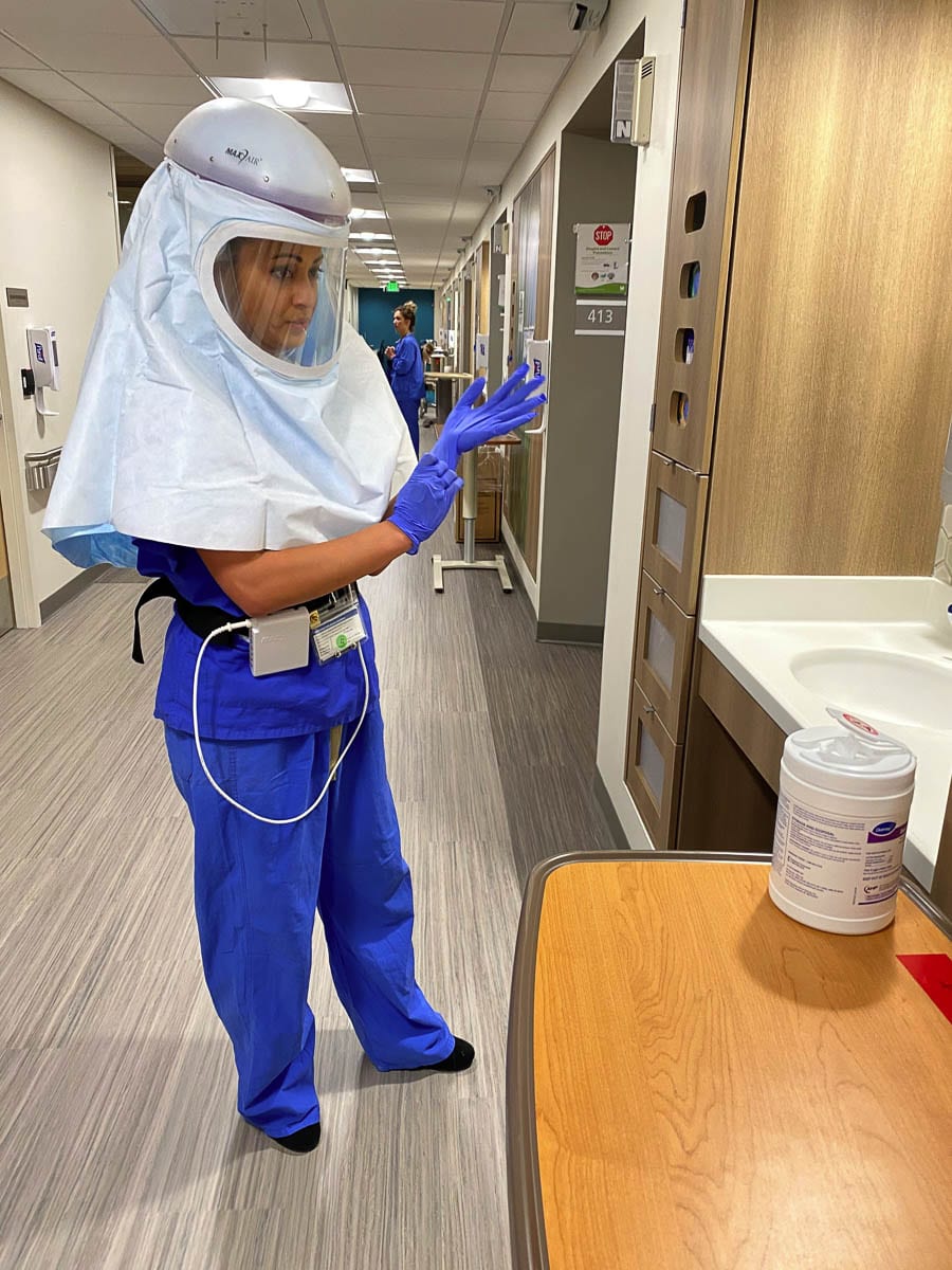 A Legacy Health RN suits up with a PAPR helmet, used to treat COVID-19 patients. Photo courtesy Legacy Health