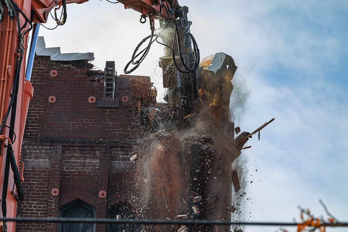 A massive hydraulic claw makes short work of the brick walls at the old New Heights church building in downtown Vancouver. Photo by Mike Schultz