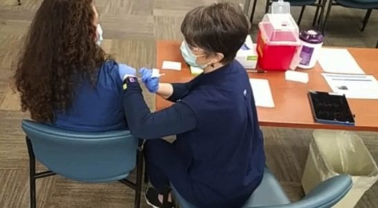 Registered Nurse Schaeffer Seabrook became the first PeaceHealth Southwest employee vaccinated for COVID-19. Photo via PeaceHealth Southwest Facebook page