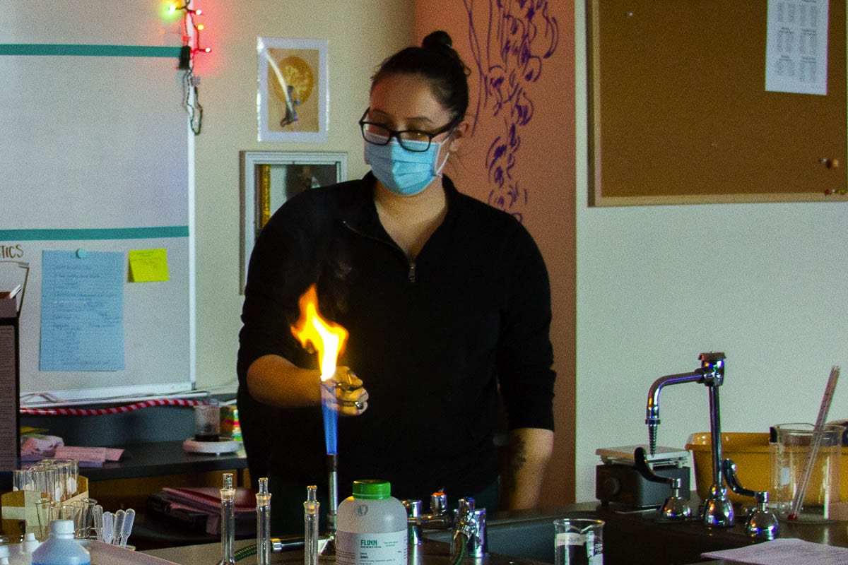 Stephanie Marshall, a high school science teacher, lights magnesium on fire to demonstrate chemical reactions during a recent science lab. Photo courtesy of Woodland School District