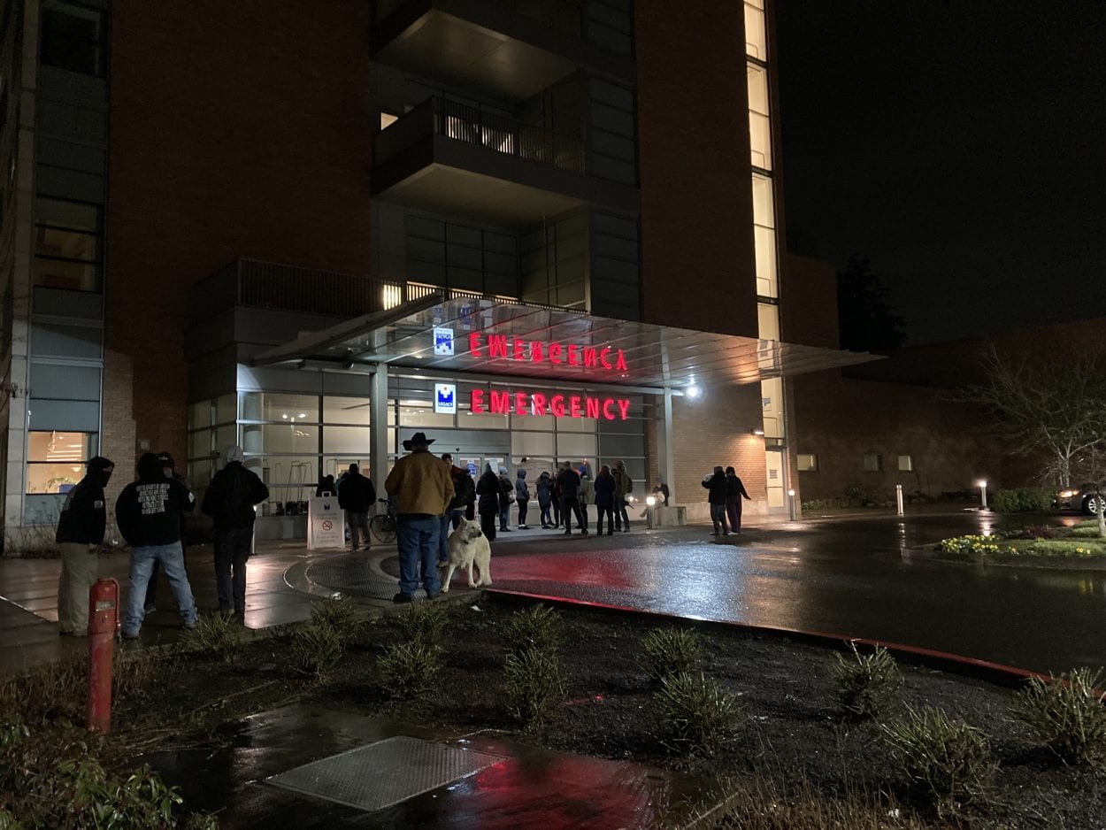 As many as 20 people gathered outside Legacy Salmon Creek Hospital on Friday night, demanding the release of a patient who had refused a COVID test. Photo by Jacob Granneman