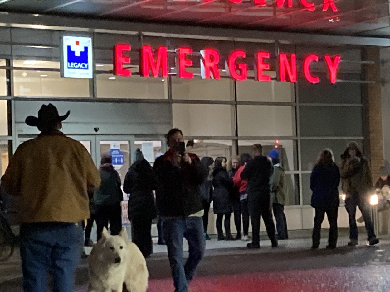 As many as 20 people gathered outside Legacy Salmon Creek Hospital on Friday night, demanding the release of a patient who had refused a COVID test. Photo by Jacob Granneman