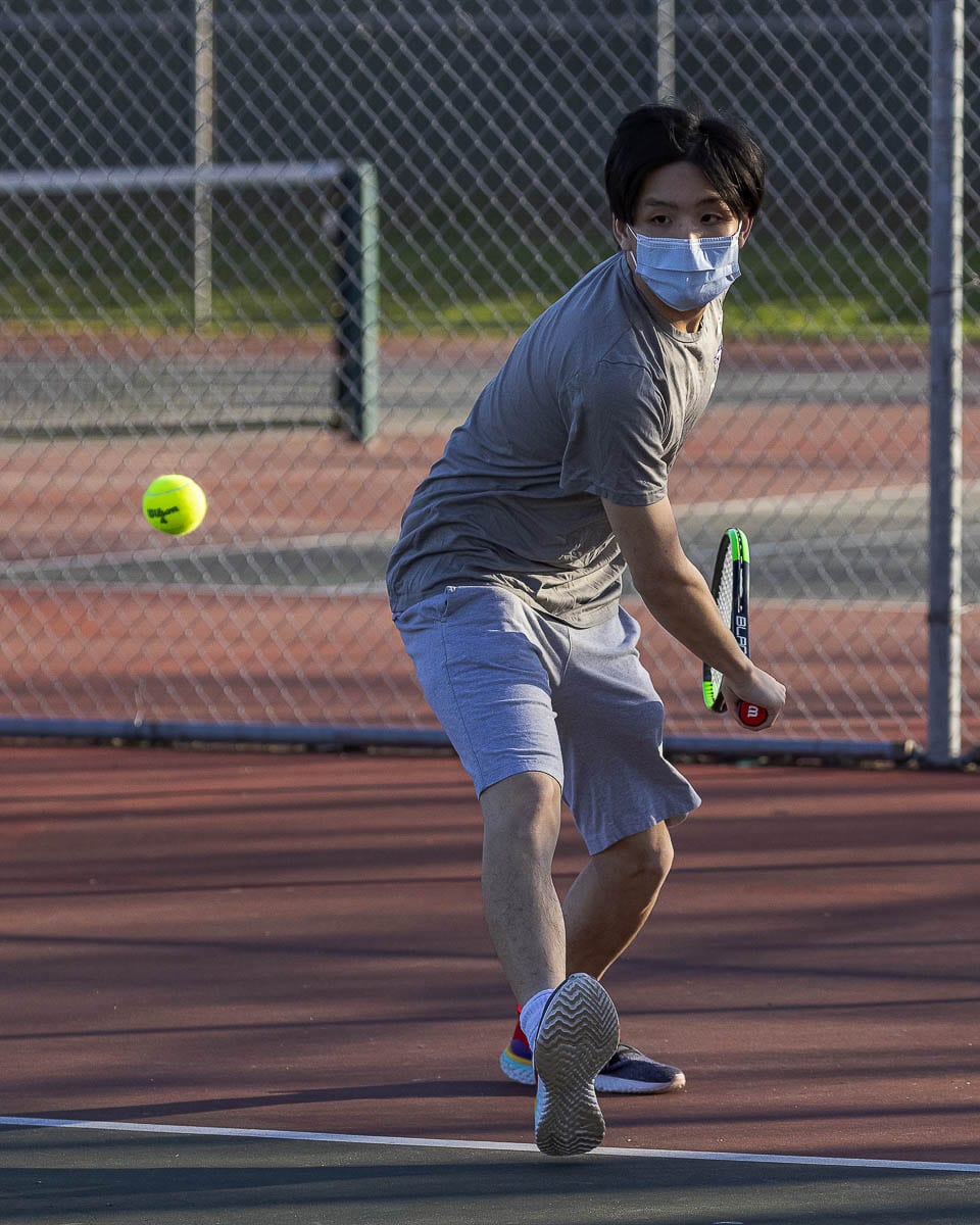 Ken Pham of Heritage played a home match Tuesday. It was the first sporting event held on campus at Heritage since last February’s basketball season. Photo by Mike Schultz