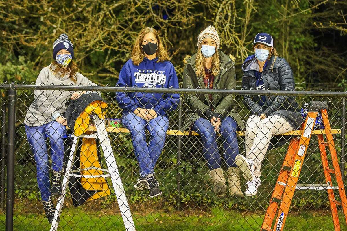 Angie Beavers, Jennie Martin, Darby Stromberg, and Jennifer Olney came prepared last week to be able to watch a Skyview football game over the fence at Kiggins Bowl. This week, more fans will be allowed inside stadiums. Photo by Mike Schultz