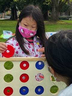 Children play Connect 4 during Saturday’s Columbia Play Project outdoor event at Esther Short Park in Vancouver. Photo courtesy of Jeanne Bennett.