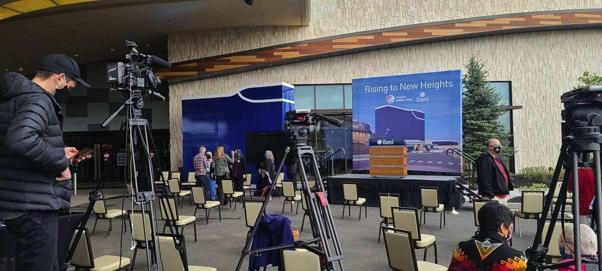 Media setting up prior to the groundbreaking ceremony at ilani as the casino starts construction on a new 14-story hotel. A display of the hotel is shown to the left of the podium. Photo by Paul Valencia