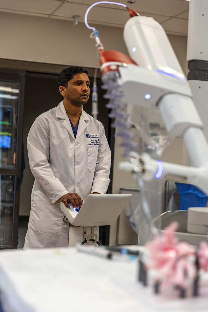Dr. Bhanu Patibandla is shown here operating the Ion robot on a set of artificial lung airways as part of the training and testing for the device. Photo by Jacob Granneman