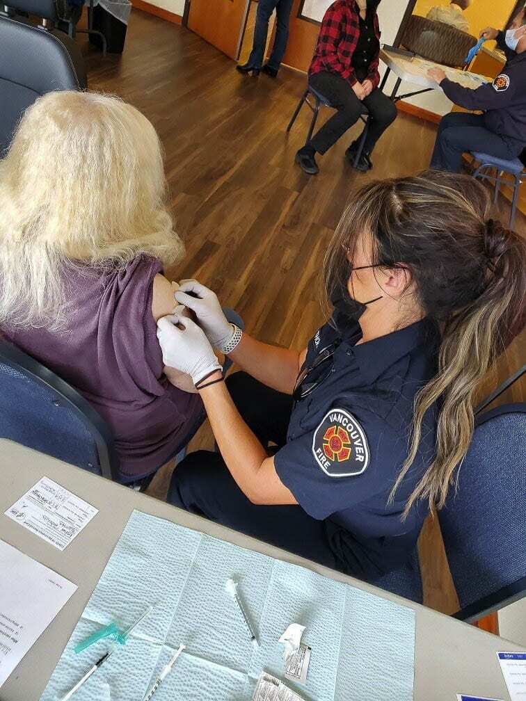 Vancouver Fire is providing two emergency trained personnel to stand by at the Tower Mall drive through vaccination clinic. Their sole responsibility is to treat anyone who may have an unexpected reaction to the vaccination. Photo courtesy of Vancouver Fire Department