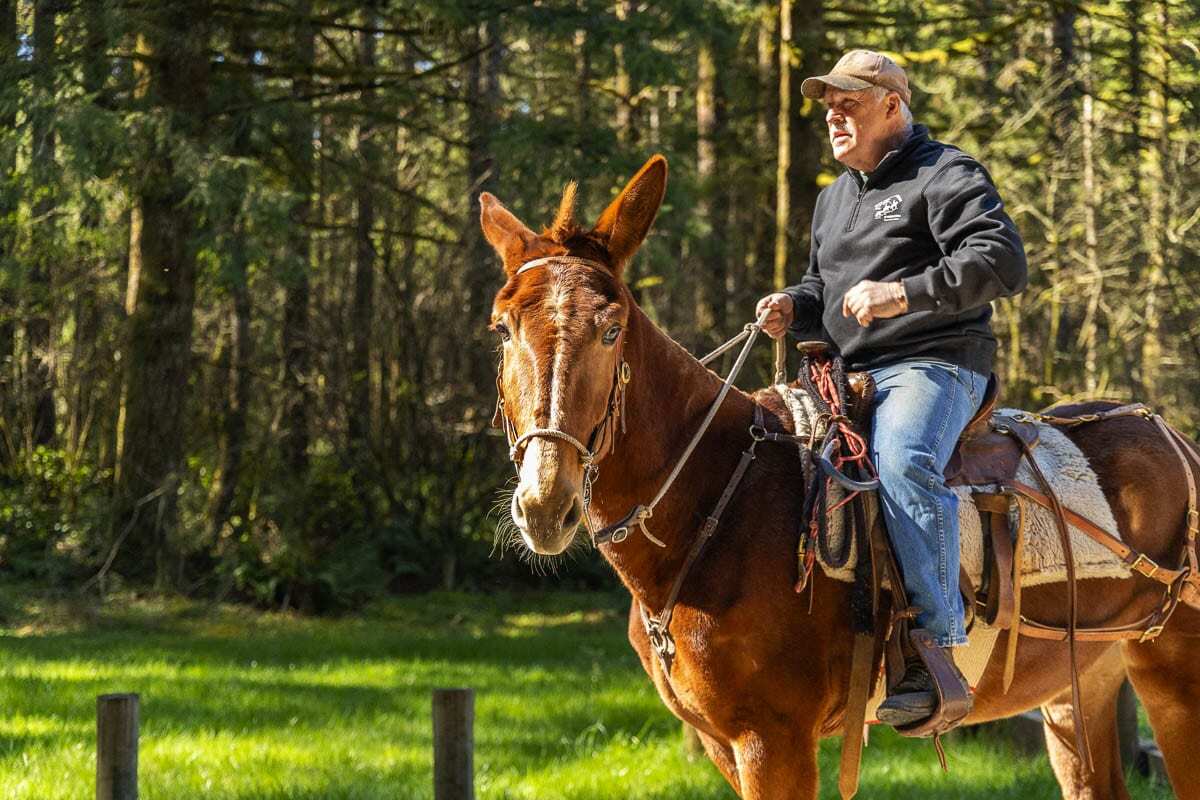 Jim Anderson is seen here riding his horse out of the Rock Creek camp, heading for the trails he loves so much. Photo by Jacob Granneman