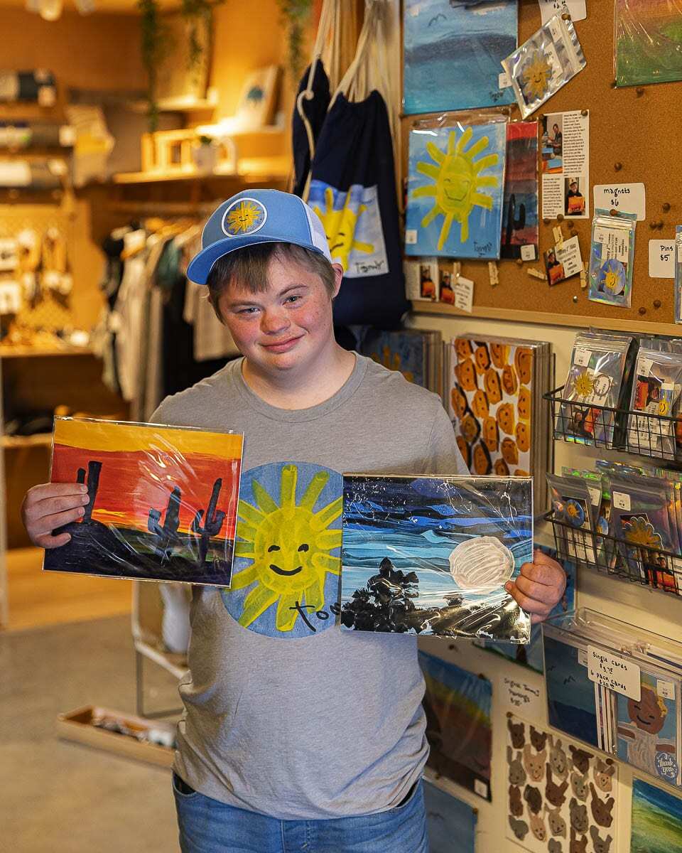 Tommy Tikka shows off the work he has for sale at Rusty Glamour in Battle Ground. Photo by Mike Schultz.