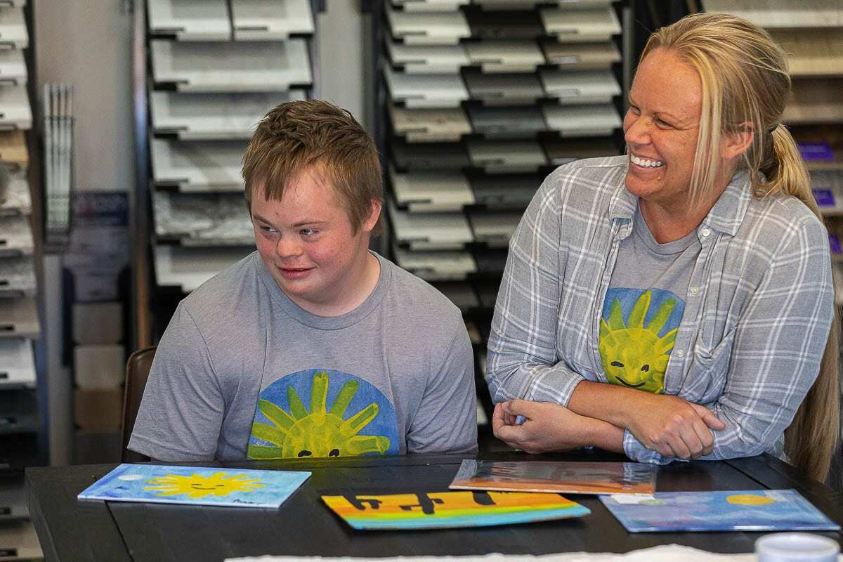 Tommy Tikka and Sarah Tikka talking and laughing about the joy of painting. Photo by Mike Schultz.