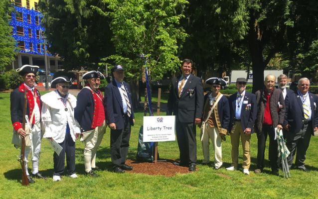 On May 22, Vancouver dedicated its own Liberty Tree as part of a special ceremony in Esther Short Park to salute America’s very first veterans who fought to secure a new nation. Shown here are (left to right) Larry Heckethorne, George Vernon, Larry Peck, Andrew Brewer, Paul Ocker, Carl Gray, Dr. Keith Weissinger (WSSAR president), Alfred Folkerts, Greg Lucas (WSSAR VP) and Jeff Lightburn (Ft. Vancouver SAR Chapter president). Photo courtesy of the Ft. Vancouver Chapter of the Sons of The American Revolution
