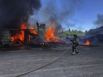 CCFR Capt. Matt Woodford stretches the attack line. Photo courtesy of Clark-Cowlitz Fire Rescue