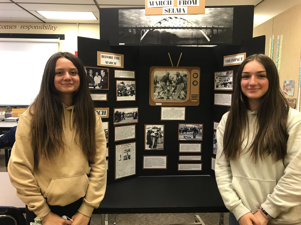 Pleasant Valley Middle School students Kristina Goldinov (left) and Abby Dubinskiy pose with their National History Day exhibit on the March from Selma to Montgomery, Alabama. Photo courtesy of Battle Ground Public Schools