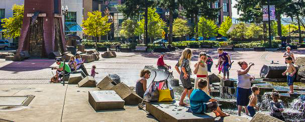 The Esther Short Park water feature is a popular spot for residents and visitors to cool off on hot summer days. The feature includes a waterfall that cascades down a path of boulders, providing comfortable seating for park goers of all ages. Photo courtesy of Vancouver Parks & Recreation