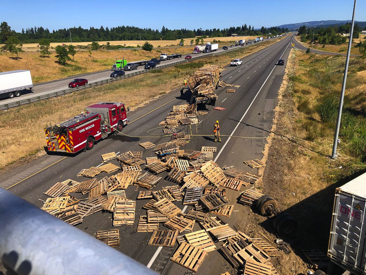The second collision involved two tractor trailers, with one truck carrying a load of pallets, leaving the roadway and catching fire. Photo courtesy of Clark-Cowlitz Fire Rescue
