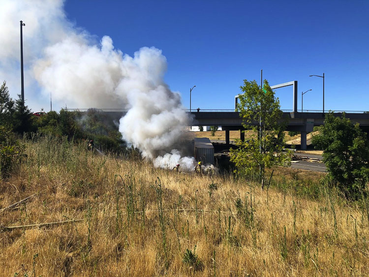 The fire spread to both vehicles and one driver was transported to the hospital by AMR with non-life threatening injuries. The fire was quickly controlled by fire crews with the majority of fire damage limited to one vehicle. Photo courtesy of Clark-Cowlitz Fire Rescue