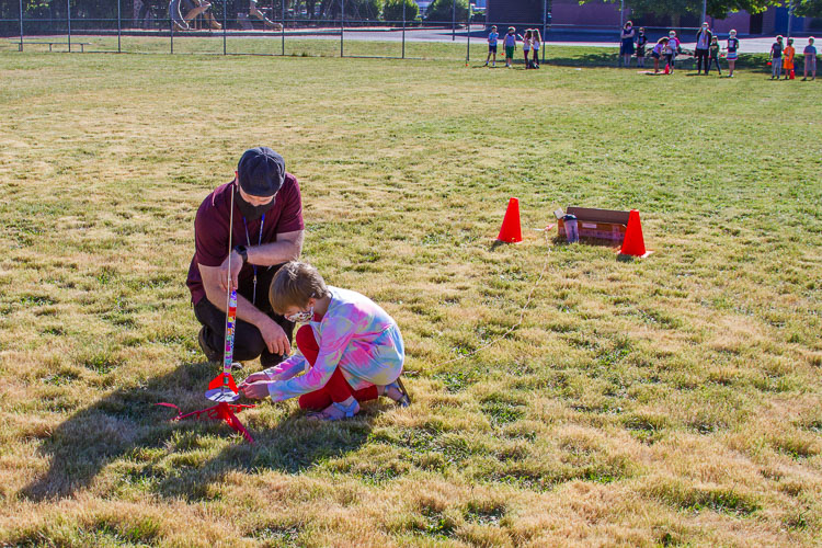 Brian Peterson, 3rd grade teacher, helps a student prepare a rocket for launch. Photo courtesy of Woodland School District