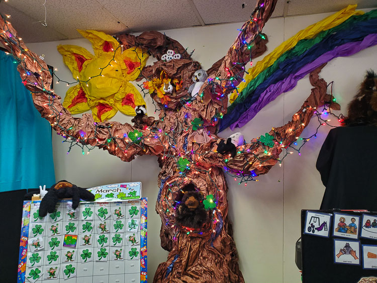 Patty Morgan uses a floor-to-ceiling paper mâché tree which changes with each season along with a huge variety of stuffed animal puppets to help teach lessons. Photo courtesy of Woodland School District