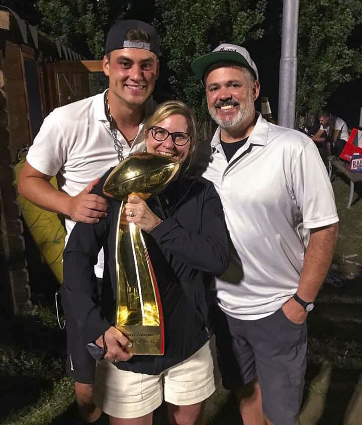 Reilly Hennessey and his parents Patrick and Connie pose with the Italian Bowl trophy on Saturday. Reilly Hennessey, a 2014 graduate of Camas High School, plays American football in Europe. He led his team, the Parma Panthers, to the championship on Saturday. Photo courtesy Reilly Hennessey