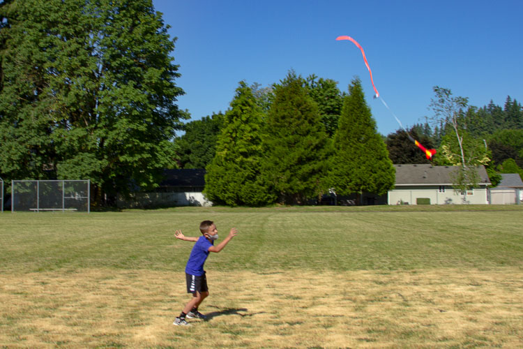 A student retrieves a rocket which returned to Earth using a streamer parachute. Photo courtesy of Woodland School District