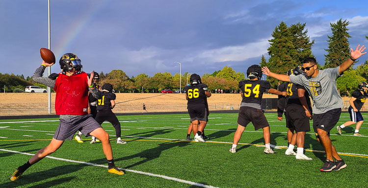 Hudson’s Bay quarterback Dean Castillo and head coach Ray Lions “playing defense” hope to find a pot of gold under this rainbow this football season. Photo by Paul Valencia