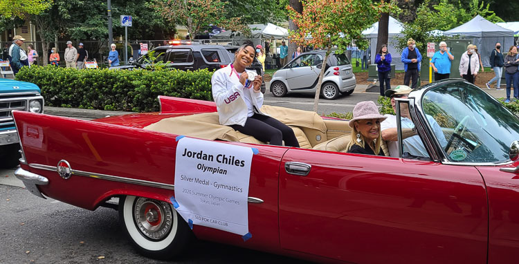 Jordan Chiles shows off her silver medal from the Olympics during a parade in her honor Sunday in Vancouver. Photo by Paul Valencia