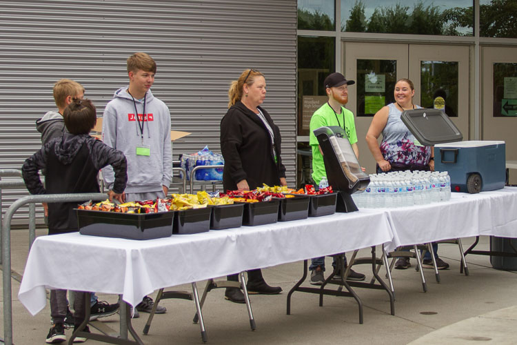 The district's Nutrition Services department provided free snacks (Director Laura Perry, far right, helps distribute snacks and water bottles). Photo courtesy of Woodland School District