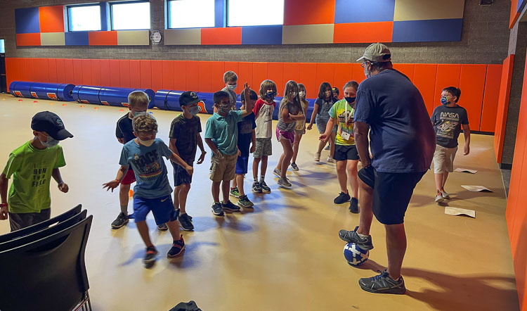 Soccer coach Jeff Brink provides a quick soccer lesson as part of a Fun Friday activity. Photo courtesy of Ridgefield School District